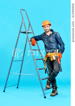 Full length portrait of handsome male construction worker climbing on ladder Full length portrait of handsome male construction worker climbing on ladder 81099808