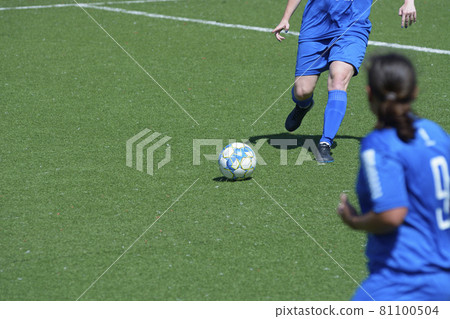 Girl football player attacking legs kicking soccer ball 81100504