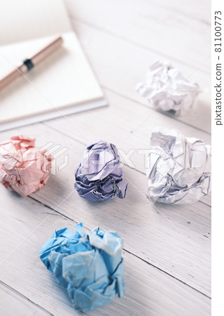 crumpled paper ball and notepad on wooden table. crumpled paper ball and notepad on wooden table. 81100773