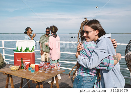 Female Friends Hugging at Party 81101679