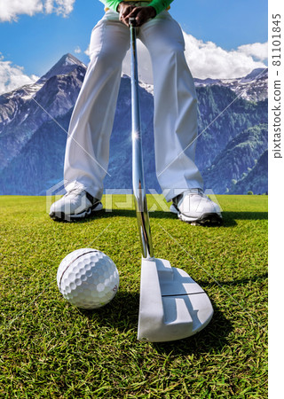 Man playing golf in Kaprun golf center against Kitzsteinhorn, Austria 81101845