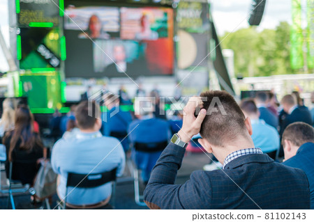 Participants of open air conference listening to speaker 81102143