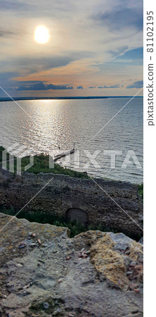 Ruined old fortress on the seashore. Blue sky. Architectural monument. Summer sea landscape. Ruined old fortress on the seashore. Blue sky. Architectural monument. Summer sea landscape. 81102195