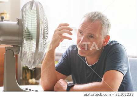 Man suffers from heat at home Man suffers from heat at home 81102222