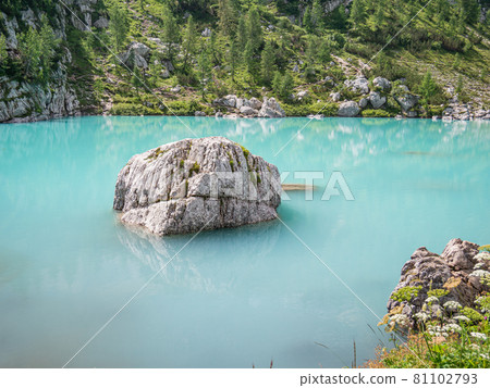 A rock in the milky water of Lake Sorapi A rock in the milky water of Lake Sorapi 81102793