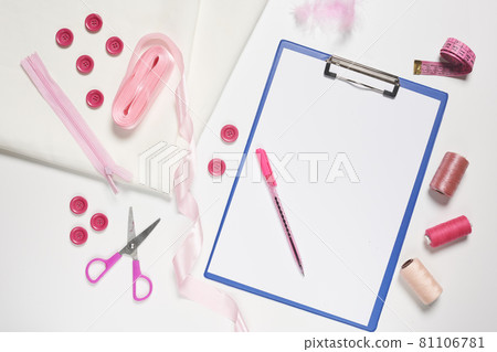 Sewing items from above. Flat lay composition with sewing accessories on light color background. Items for sewing, Sewing clothes, measuring tape, tailoring scissors, threads, buttons and needles 81106781