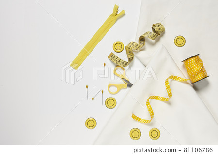 Sewing items from above. Flat lay composition with sewing accessories on light color background. Items for sewing, Sewing clothes, measuring tape, tailoring scissors, threads, buttons and needles Sewing items from above. Flat lay composition with sewing accessories on light color background. Items for sewing, Sewing clothes, measuring tape, tailoring scissors, threads, buttons and needles 81106786