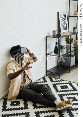 Man playing video game at home Man playing video game at home 81106979