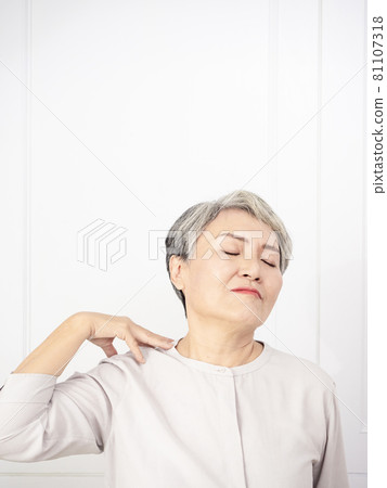 Sick Asian mature woman touching neck having shoulder and neck pain. Healthcare and medicine concept. 81107318