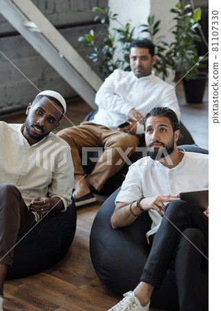 Three young Muslim businessmen sitting in armchairs at seminar or training 81107330