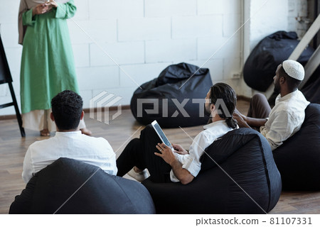 Row of Muslim businessmen in formalwear attending seminar 81107331