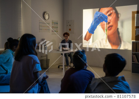 Youthful schoolkids watching video about scientific experiment Youthful schoolkids watching video about scientific experiment 81107578