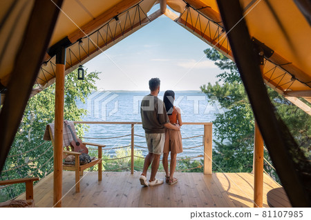 rear view of affectionate couple enjoying summer vacation rear view of affectionate couple enjoying summer vacation 81107985