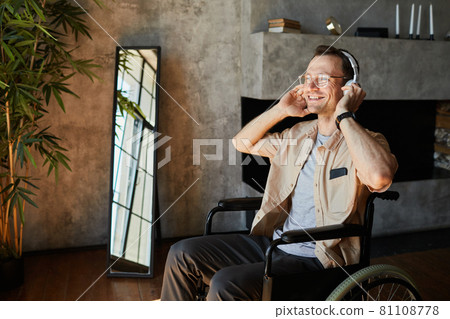 Happy Man in Wheelchair Enjoying Music Happy Man in Wheelchair Enjoying Music 81108778