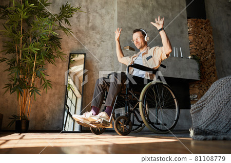 Man in Wheelchair Enjoying Music Man in Wheelchair Enjoying Music 81108779