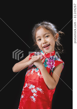 A girl wears a cheongsam on Chinese New Year. A girl wears a cheongsam on Chinese New Year. 81109267