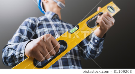 A male engineer is working and using a water level meter. A male engineer is working and using a water level meter. 81109268