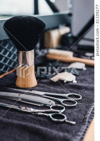 Close-up shaving brush, razor, scissors, combs on the table on a black towel. Professional barber tools and equipment. Barbershop. Professional mens shaving and haircut, hair care. Vertical shot Close-up shaving brush, razor, scissors, combs on the table on a black towel. Professional barber tools and equipment. Barbershop. Professional mens shaving and haircut, hair care. Vertical shot 81109277