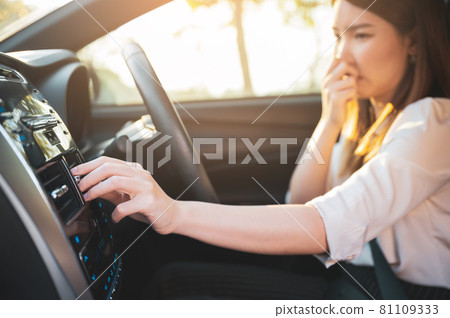 Young Asian woman holding her nose because of bad smell after turn on car air conditioning Young Asian woman holding her nose because of bad smell after turn on car air conditioning 81109333