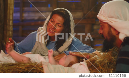 Mary and Joseph kissing and touching baby Jesus Mary and Joseph kissing and touching baby Jesus 81110166