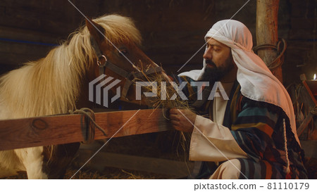 Joseph giving hay to horse Joseph giving hay to horse 81110179