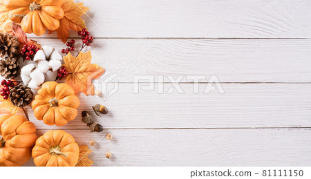 Autumn background decoration from dry leaves and pumpkin on wooden background. Flat lay, top view with copy space for Autumn, fall, Thanksgiving concept. Autumn background decoration from dry leaves and pumpkin on wooden background. Flat lay, top view with copy space for Autumn, fall, Thanksgiving concept. 81111150