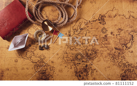 Happy Columbus Day concept. Vintage compass, paper boat, rope on retro treasure manuscript. Flat lay, top view with copy space. Happy Columbus Day concept. Vintage compass, paper boat, rope on retro treasure manuscript. Flat lay, top view with copy space. 81111152