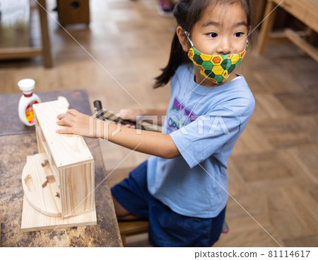 Elementary school girls enjoying woodworking 81114617