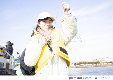 Young woman enjoying sea fishing 81114808