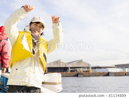 Young woman enjoying sea fishing Young woman enjoying sea fishing 81114809