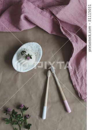 Soap bar or solid shampoo on a soap dish, bamboo toothbrush and towel top view with copyspace. Accessories for personal hygiene. Plastic free and eco friendly products in household Soap bar or solid shampoo on a soap dish, bamboo toothbrush and towel top view with copyspace. Accessories for personal hygiene. Plastic free and eco friendly products in household 81115031