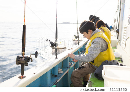 Elementary school boys enjoying fishing 81115260
