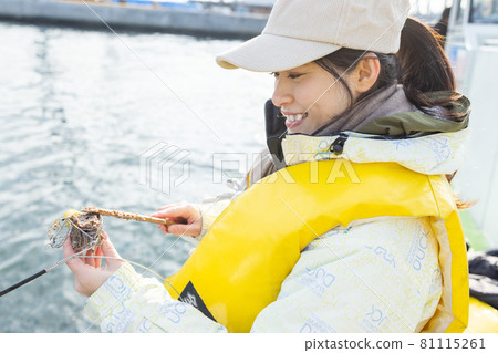 Young woman enjoying fishing 81115261