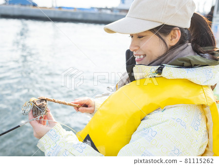 Young woman enjoying fishing 81115262