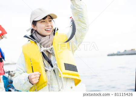 Cute woman who caught horse mackerel Cute woman who caught horse mackerel 81115426
