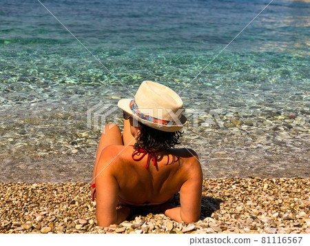 Woman with bikini sitting close to the beach.Ionian Sea Albania  81116567