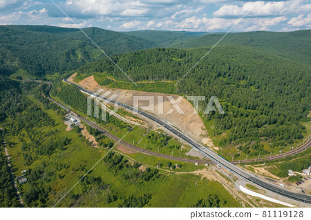 The Baikal serpentine road - aerial view of natural mountain valley with serpantine road, Trans-Siberian Highway, Russia, Kultuk, Slyudyanka The Baikal serpentine road - aerial view of natural mountain valley with serpantine road, Trans-Siberian Highway, Russia, Kultuk, Slyudyanka 81119128
