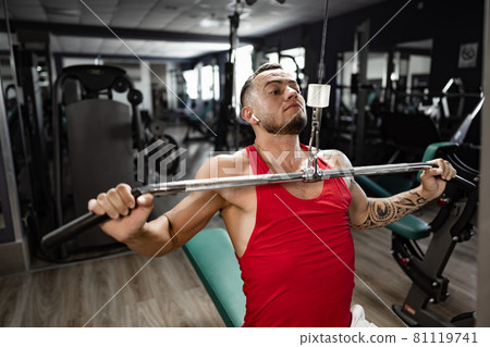 Portrait of man bodybuilder in red shirt in gym Portrait of man bodybuilder in red shirt in gym 81119741