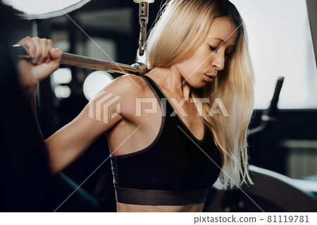 Fitness woman in sport outfit exercising in gym 81119781