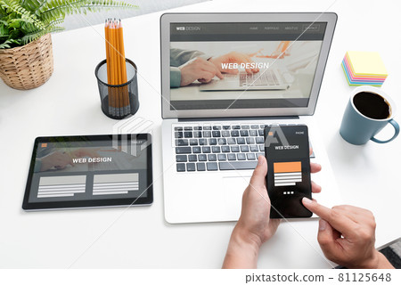 Web designer working with multiple devices 81125648