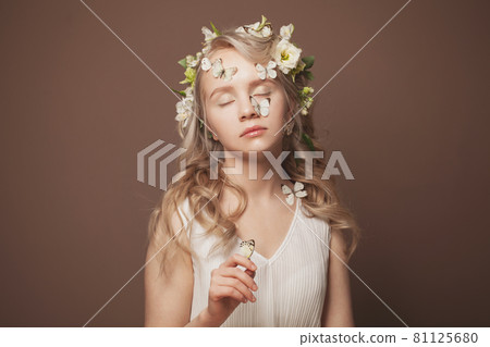 Dreaming young woman with butterflies and flowers. Dreams on love and spring 81125680