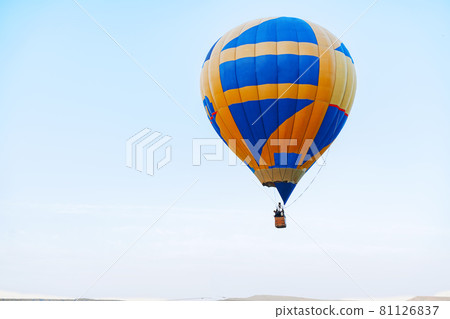 Multicolored air balloon in clear blue sky Multicolored air balloon in clear blue sky 81126837