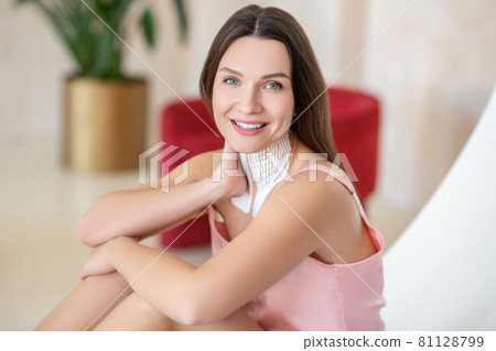 Young woman in pink lingerie and tapes on her neck looking relaxed Young woman in pink lingerie and tapes on her neck looking relaxed 81128799