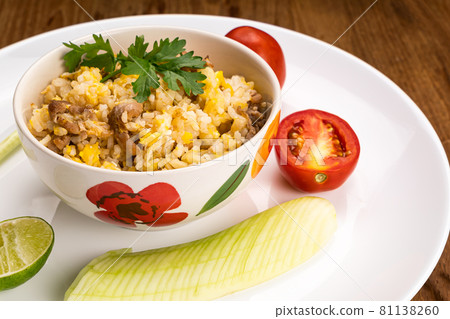 High angle view of thai style homemade delicious pork and egg fried rice in ceramic bowl. 81138260