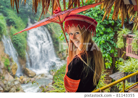 A female tourist dressed in the traditional dress of the inhabitants of the Vietnamese mountains, the Hmong. Woman in Sapa in the fog, Northwest Vietnam. Vietnam travel concept. UNESCO heritage A female tourist dressed in the traditional dress of the inhabitants of the Vietnamese mountains, the Hmong. Woman in Sapa in the fog, Northwest Vietnam. Vietnam travel concept. UNESCO heritage 81143355