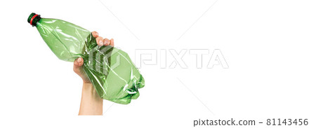 Close-up of a female hand holding a green plastic bottle on a white background. Isolated Close-up of a female hand holding a green plastic bottle on a white background. Isolated 81143456