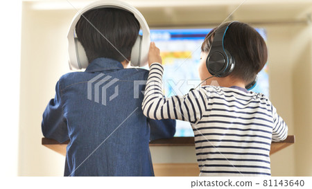 Back view of a boy wearing a headset and enjoying video games 81143640
