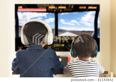 Back view of a boy wearing a headset and enjoying video games 81143642