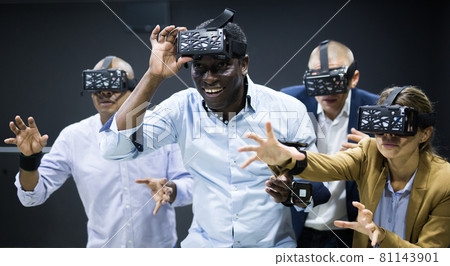 Multicultural friends using virtual reality headsets 81143901