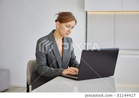 Female worker with laptop in office has online learning. Female worker with laptop in office has online learning. 81144427